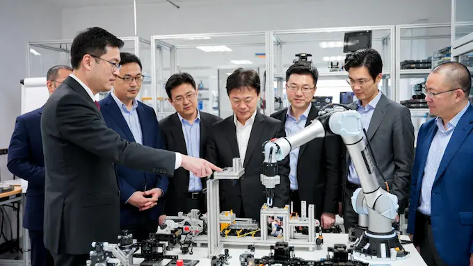 LG and Robotis engineers with robots